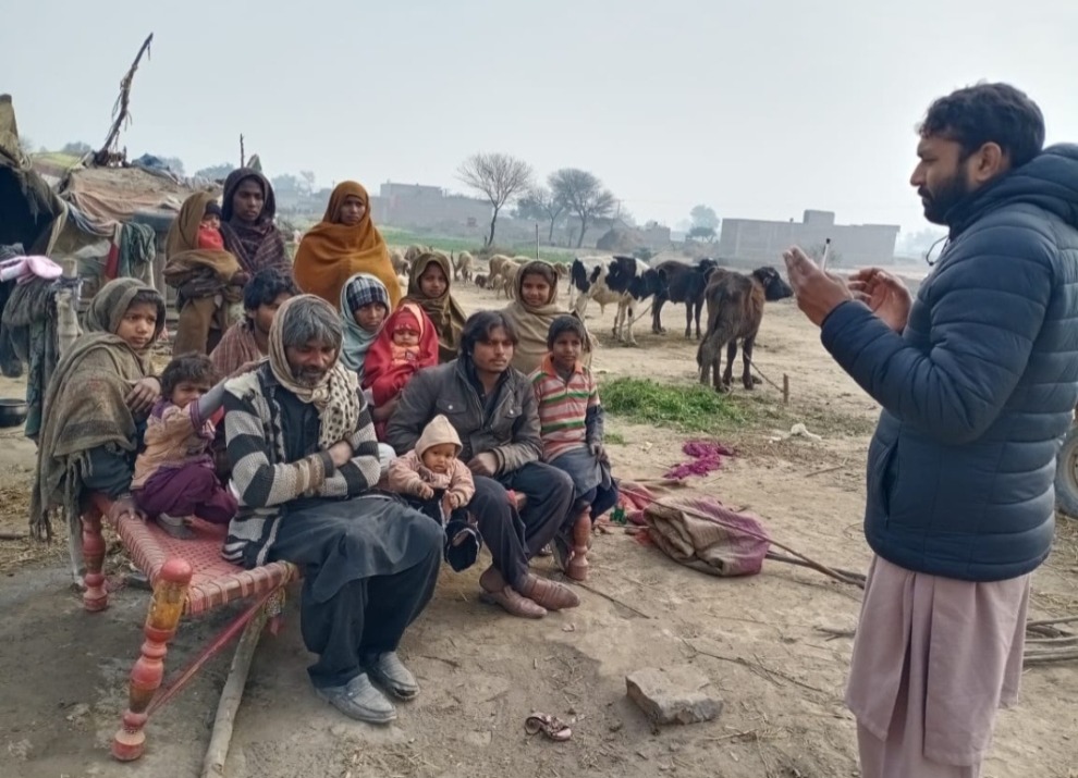 Man talking to a group of people in Pakistan