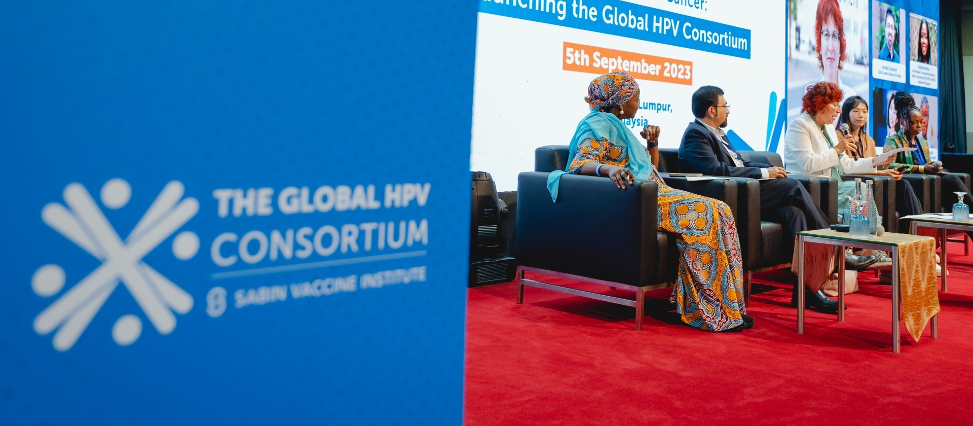 Panelists on stage at the Global HPV Consortium