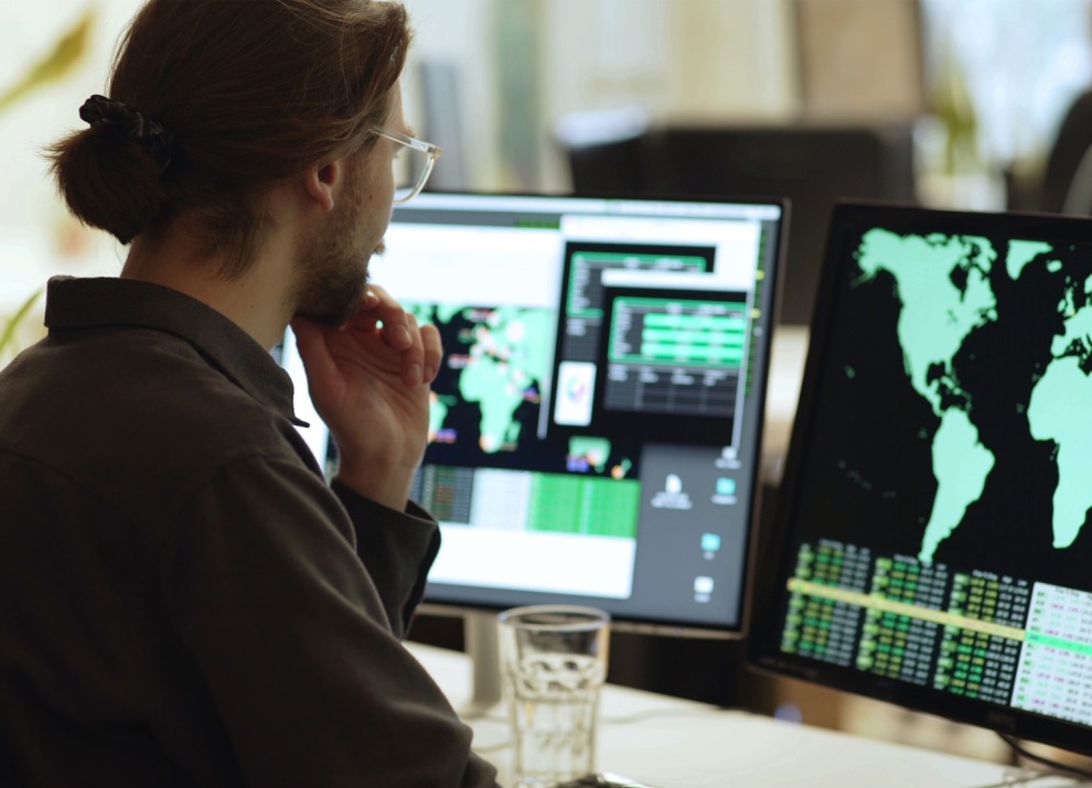 Person reviewing graphs and maps on a computer