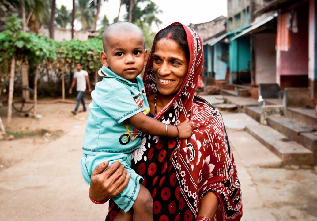 Mother-holding-child-in-village