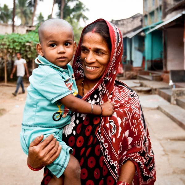 Mother-holding-child-in-village
