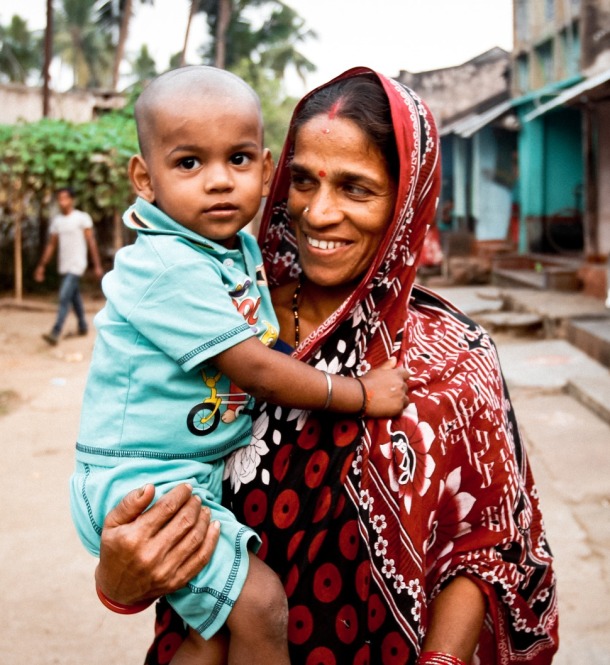 Mother-holding-child-in-village