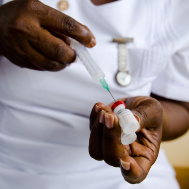 Nurse-filling-vaccine-syringe