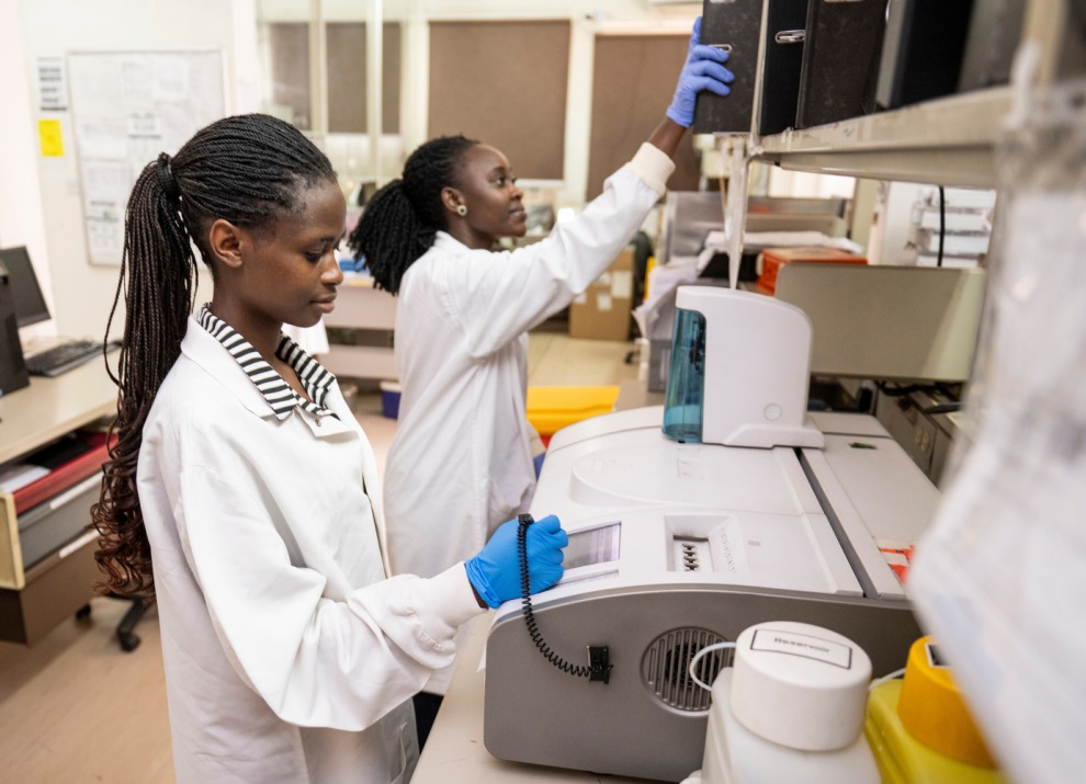 Lab technicians at Makerere University Walter Reed Project in Kampala, Uganda, analyze blood samples from clinical trial volunteers, December 18, 2023.