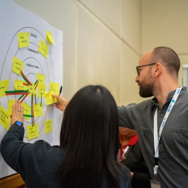 Two people reviewing a poster at the VARN2023 conference