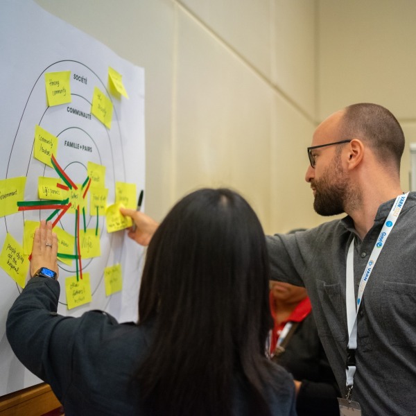 Two people reviewing a poster at the VARN2023 conference