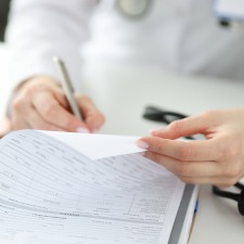 Doctor filling out paperwork
